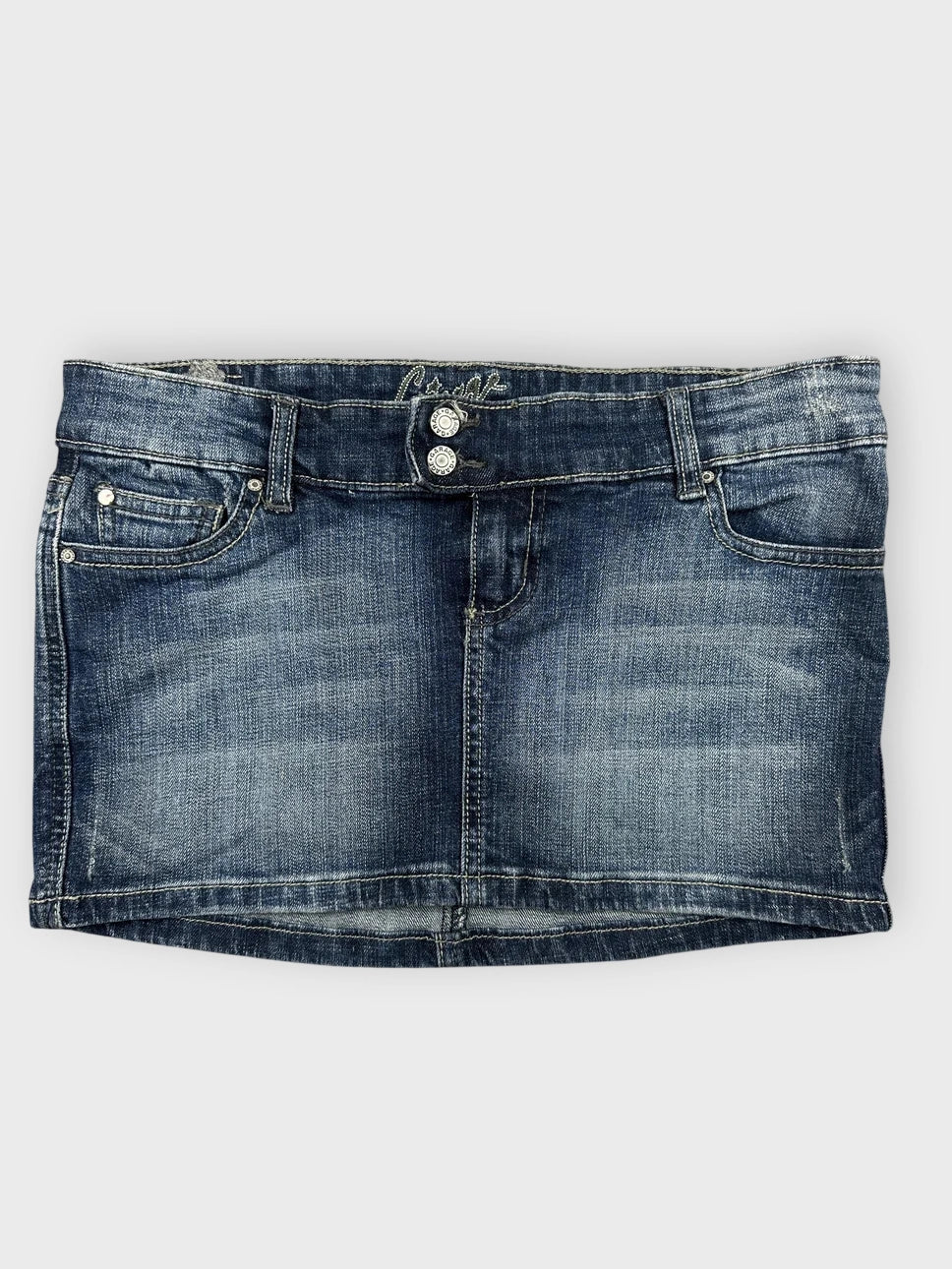 Front view of blue denim mini skirt featuring button details.
