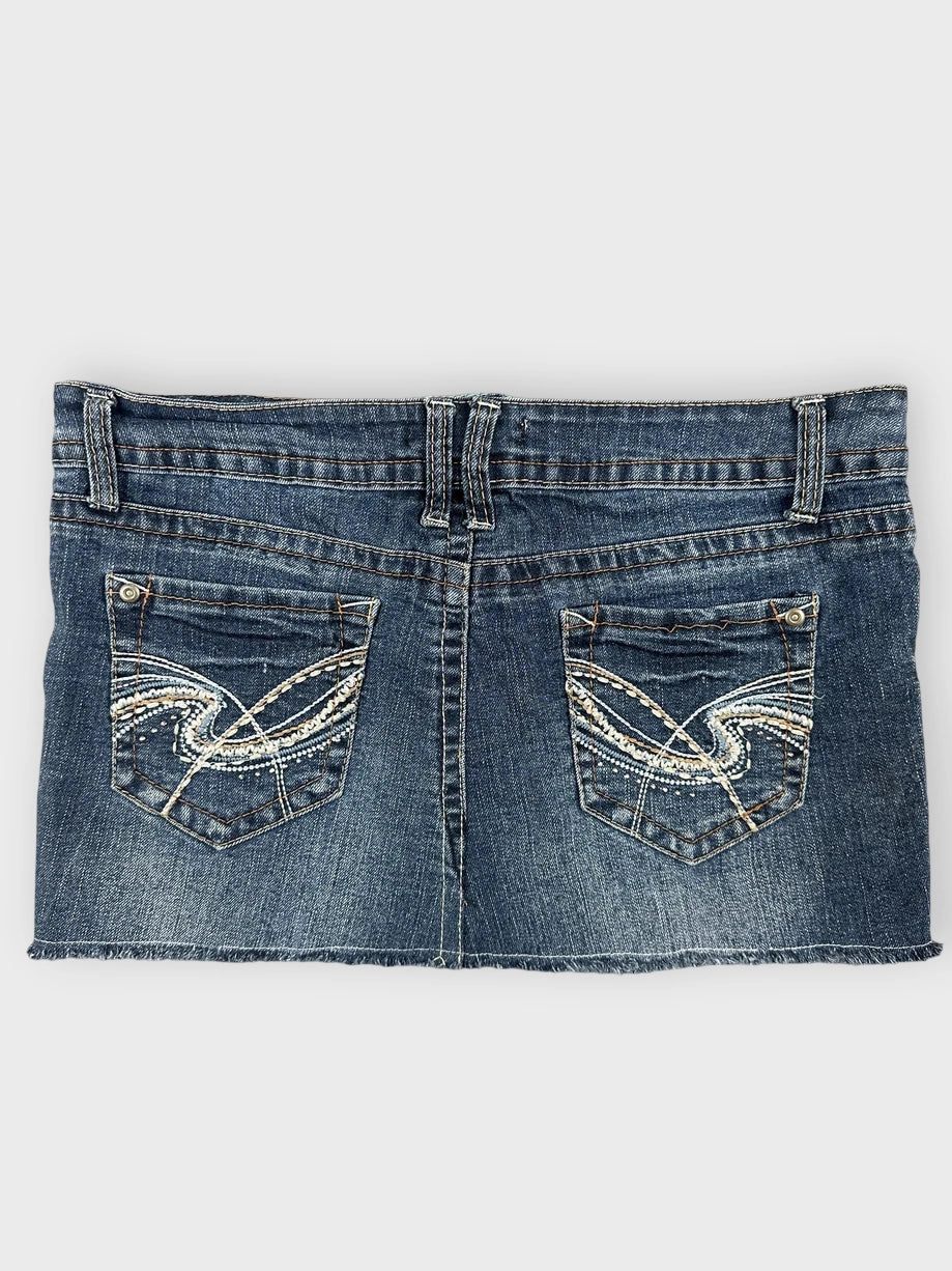 Denim mini skirt back view featuring distressed dark blue fabric and decorative stitching.