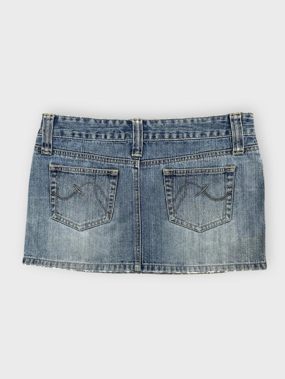 Denim mini skirt in light blue with distressed hem back view
