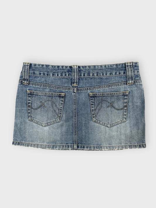 Denim mini skirt in light blue with distressed hem back view