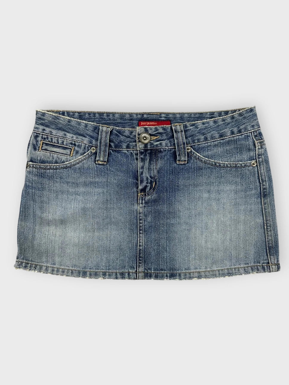 Denim mini skirt in light blue with distressed hem front view