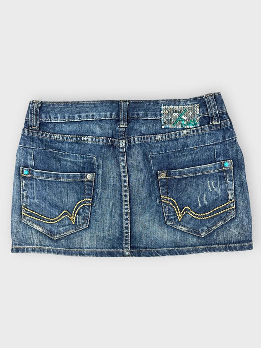 Denim mini skirt back view with decorative stitching and pocket details.