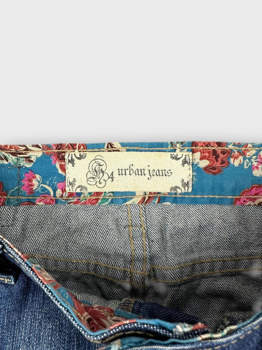 Detail view of denim mini skirt with floral lining in blue.