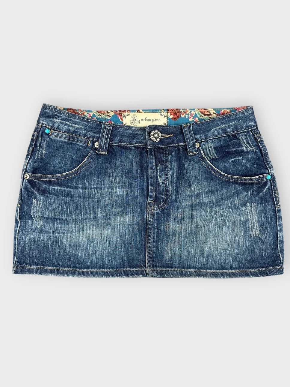 Denim mini skirt in dark blue with floral lining front view.