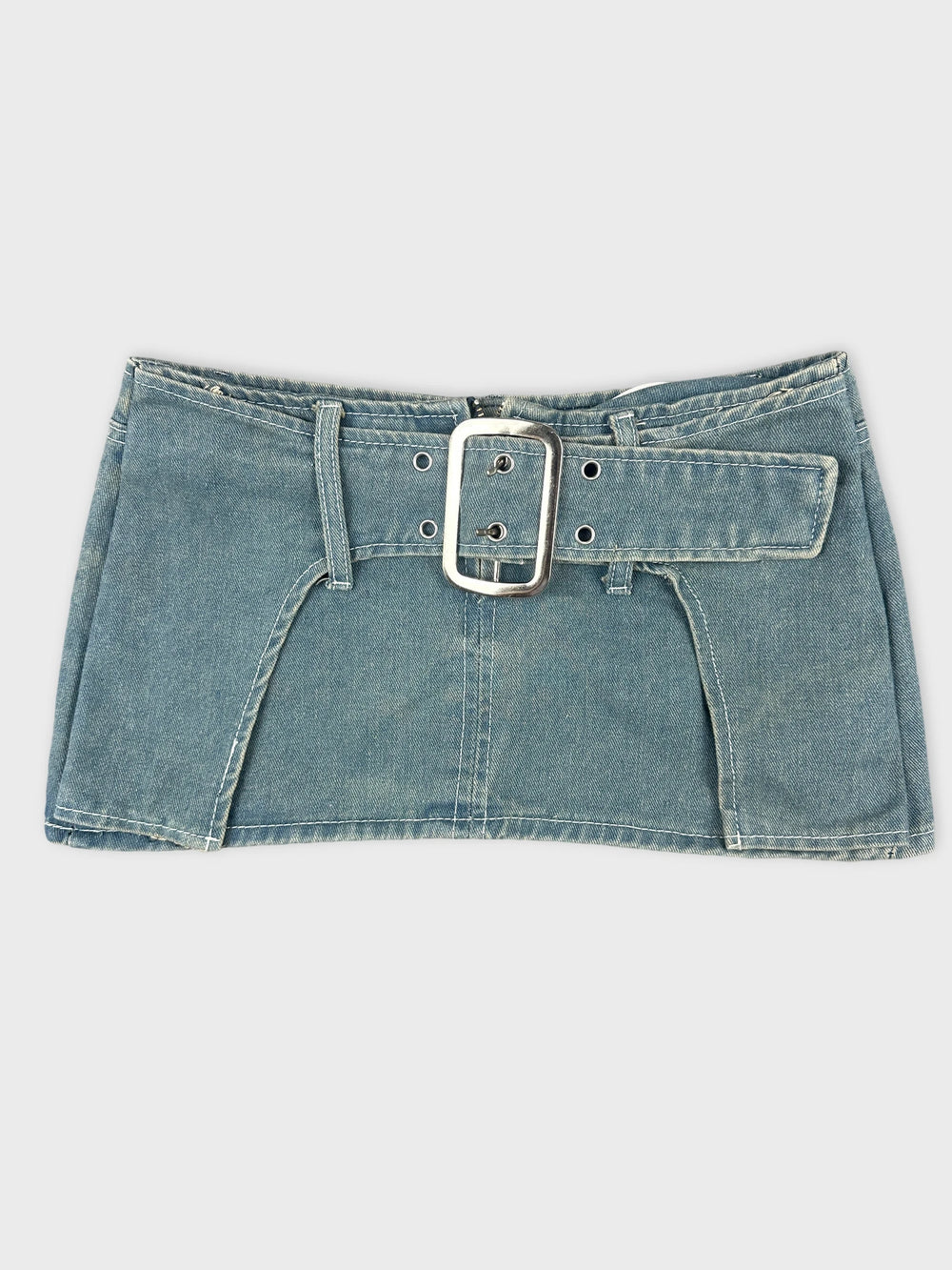 Front view of denim mini skirt with statement buckle in blue.