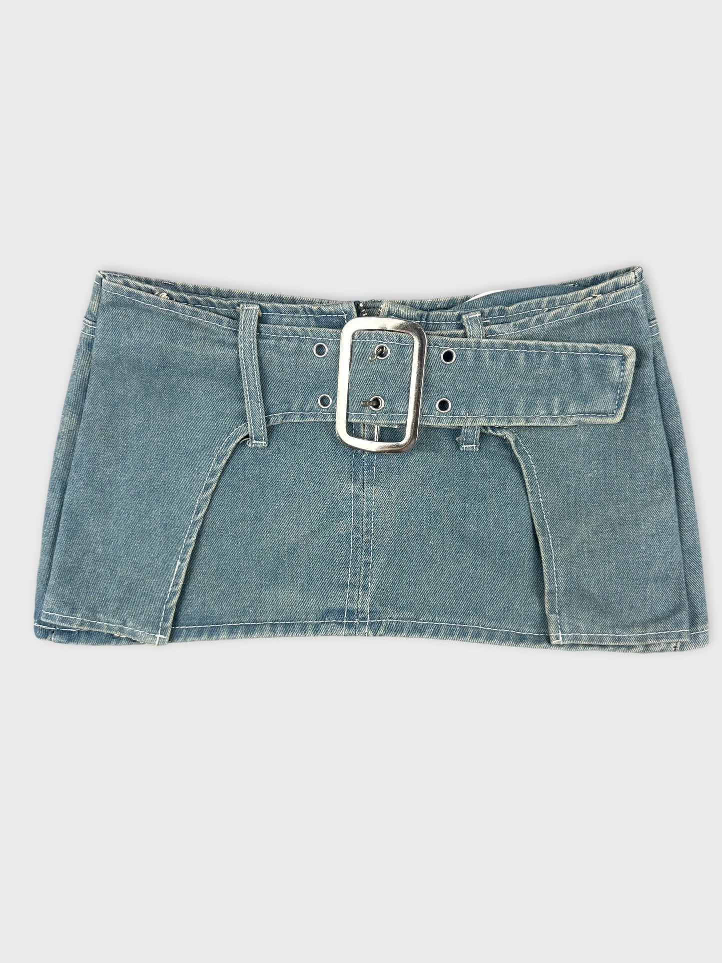 Front view of denim mini skirt with statement buckle in blue.