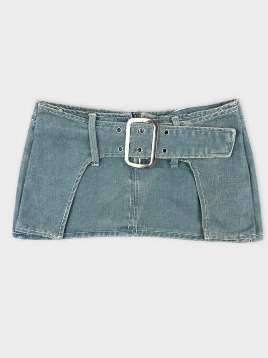 Front view of denim mini skirt with statement buckle in blue.