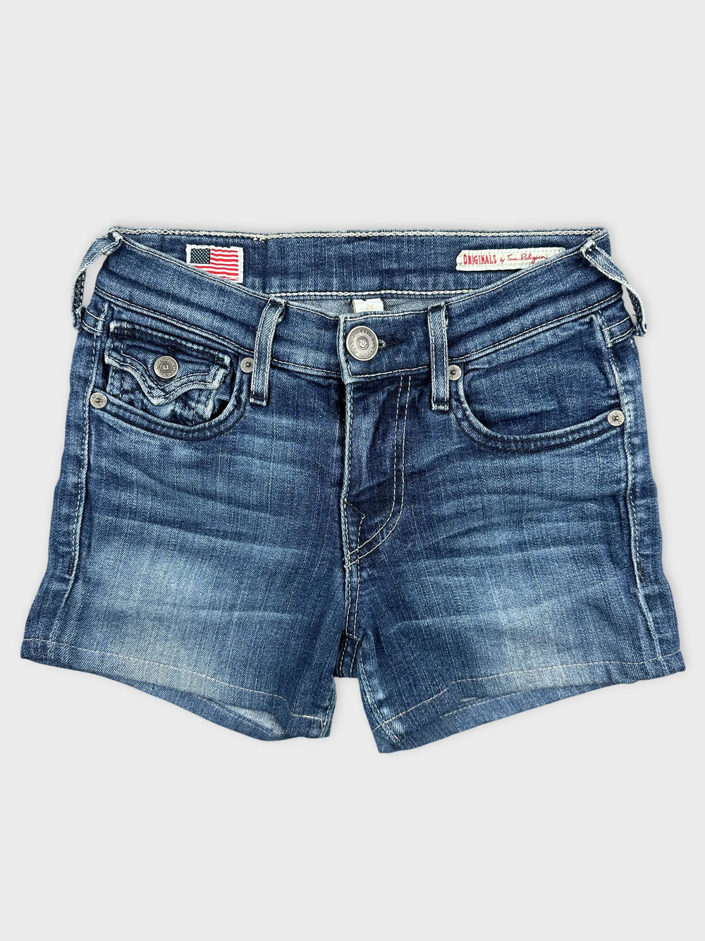 Front view of denim shorts in classic blue with frayed hemline.