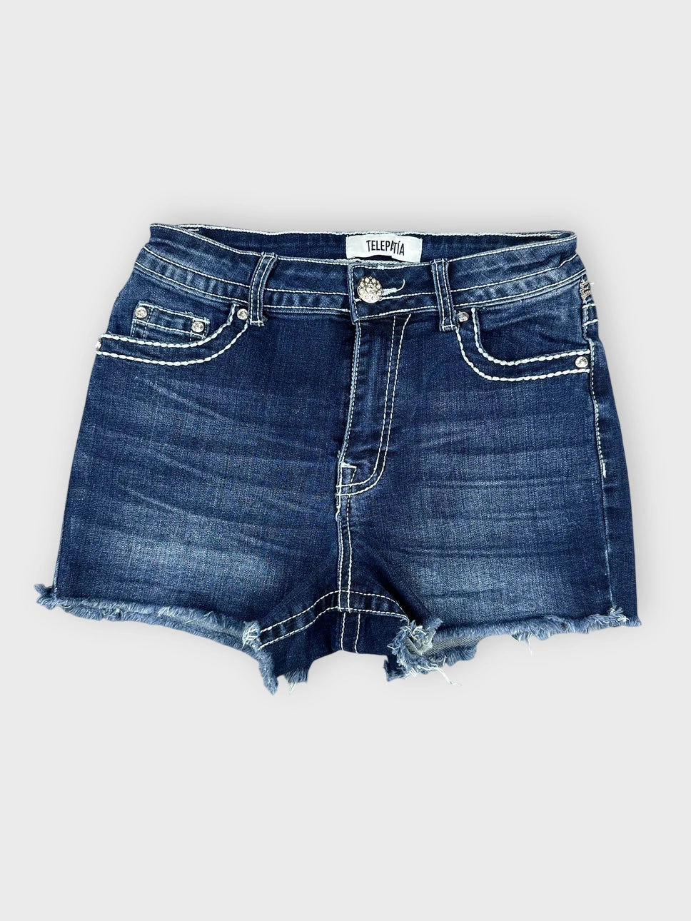 Distressed denim mini shorts in dark blue front view with frayed hem.