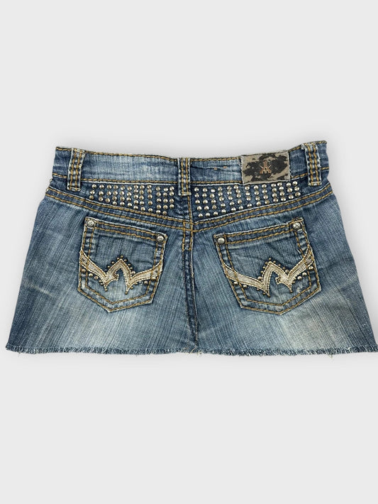 Distressed denim mini skirt with studs back view.