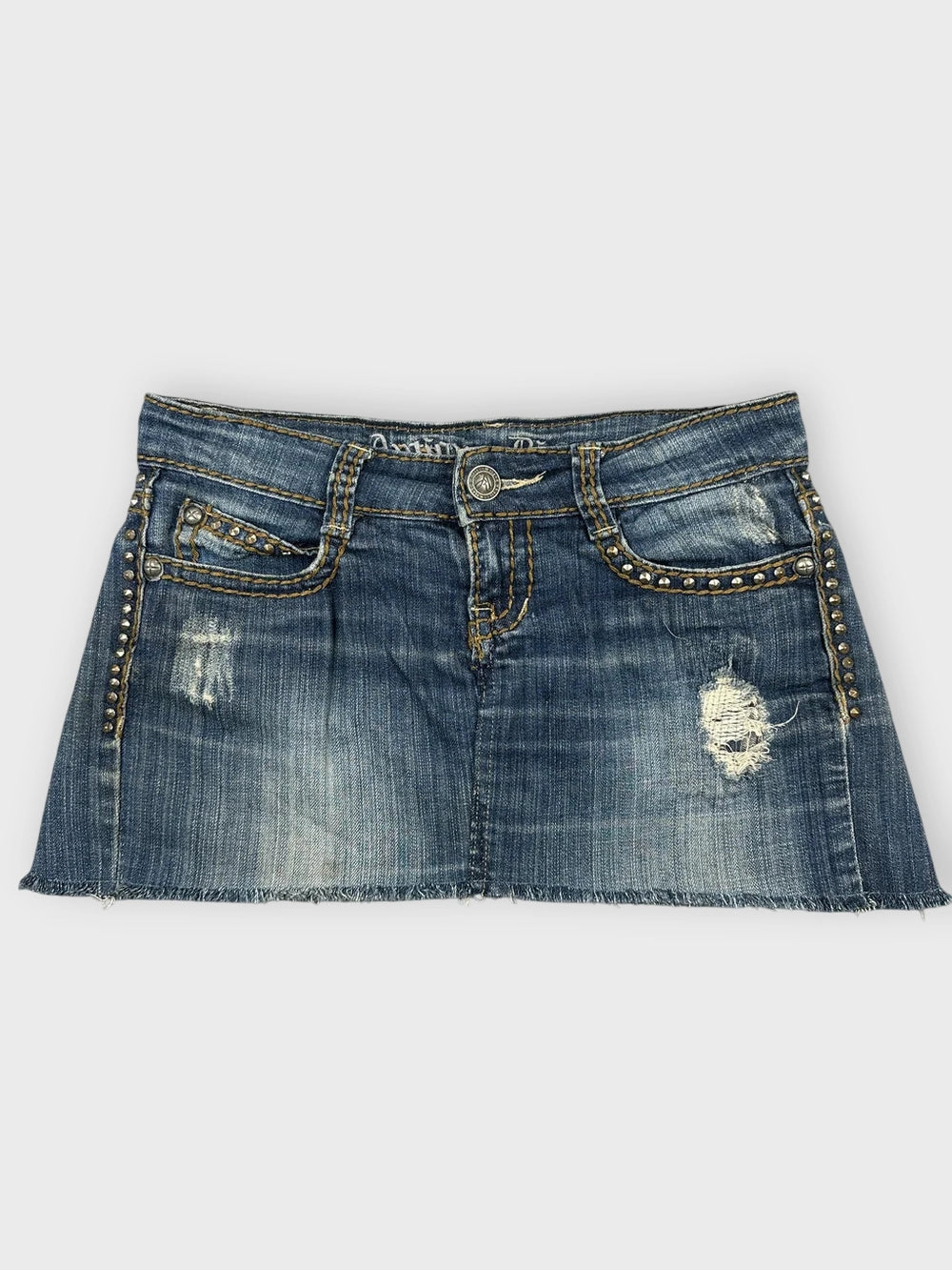 Distressed denim mini skirt in blue with studded detail front view
