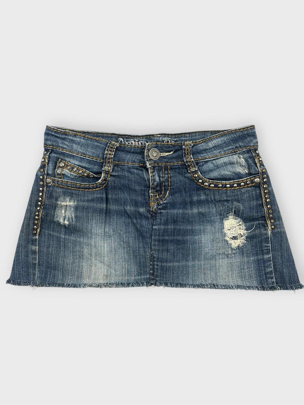 Distressed denim mini skirt in blue with studded detail front view