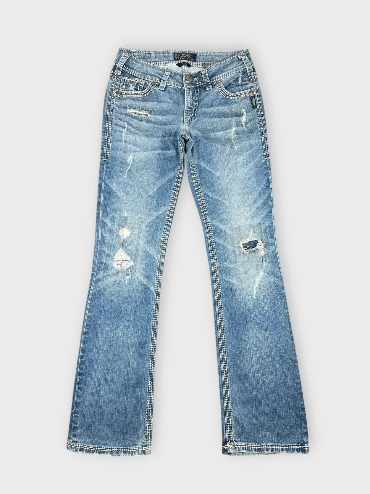 Distressed light blue denim jeans with frayed details front view