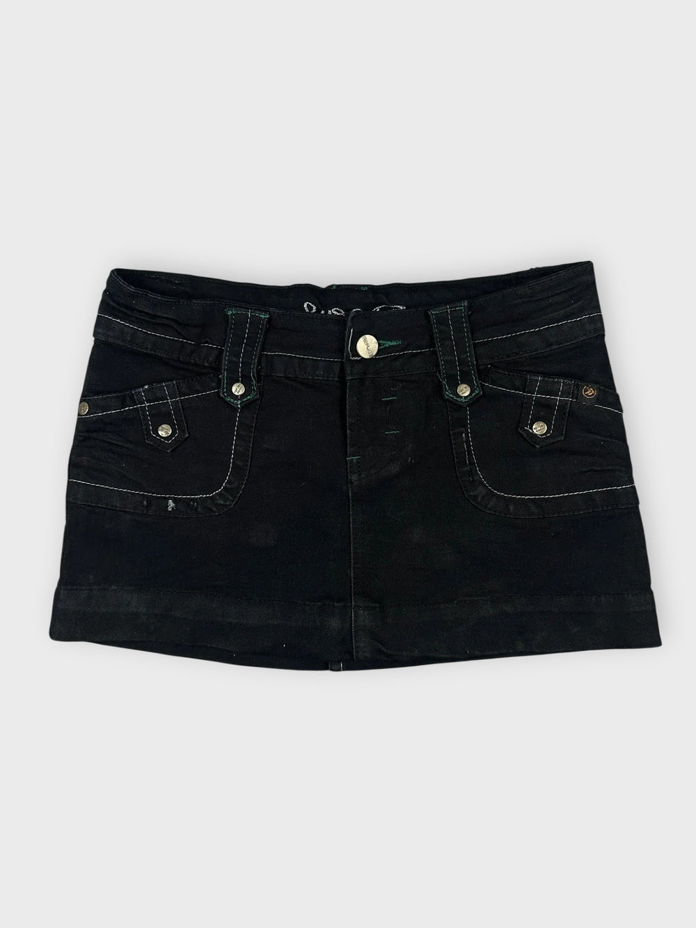 Edgy black mini skirt with pockets front view featuring a slim waistband.