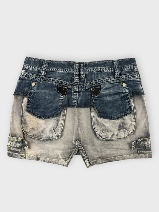 Back view of an edgy denim mini skirt with ruffle detailing in faded blue.