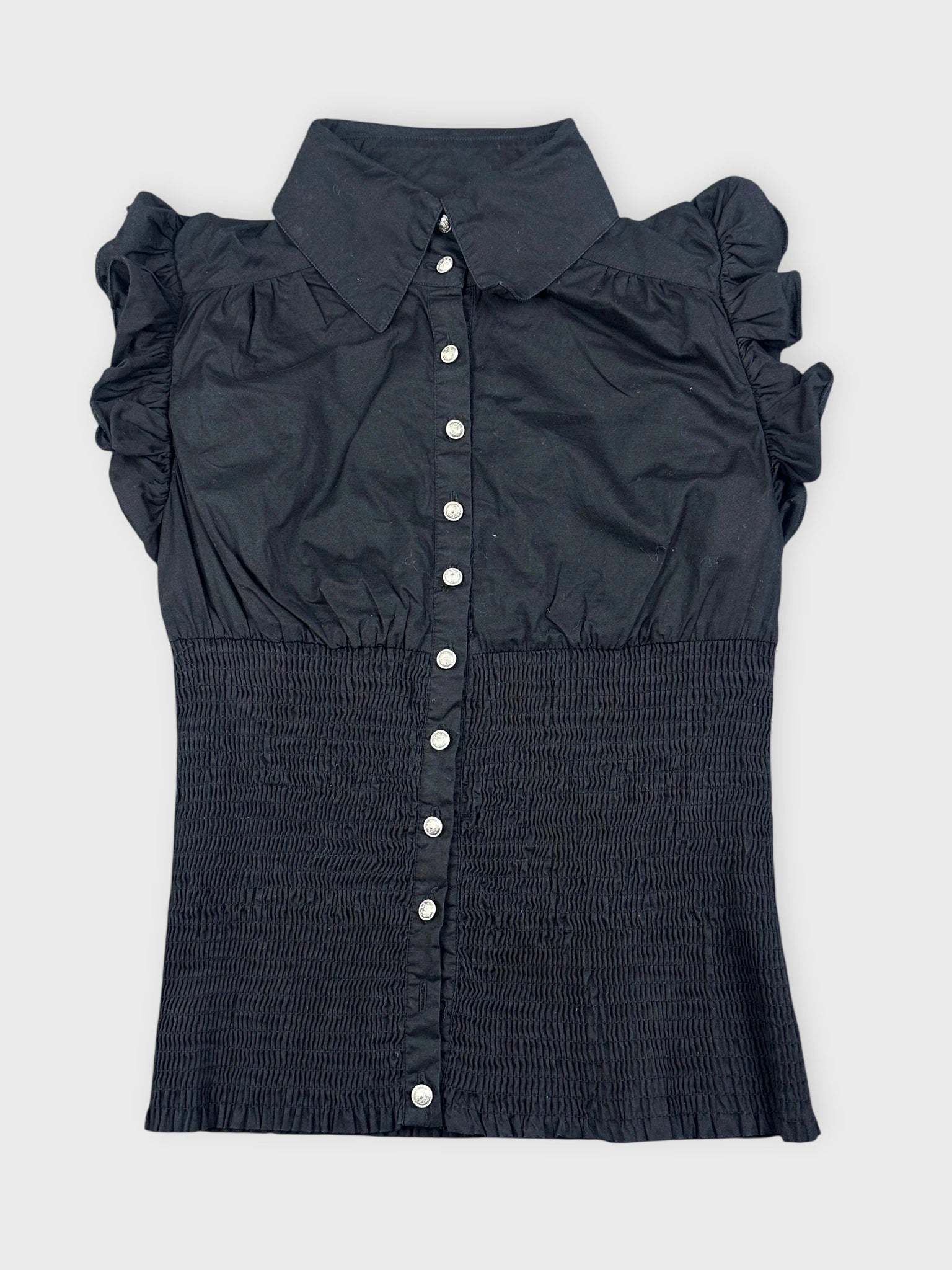 Black ruffled blouse featuring button closure in front view.