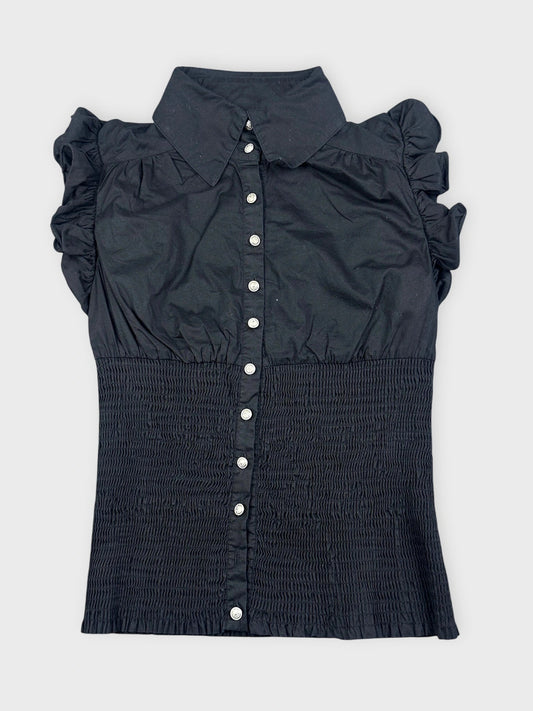 Black ruffled blouse featuring button closure in front view.