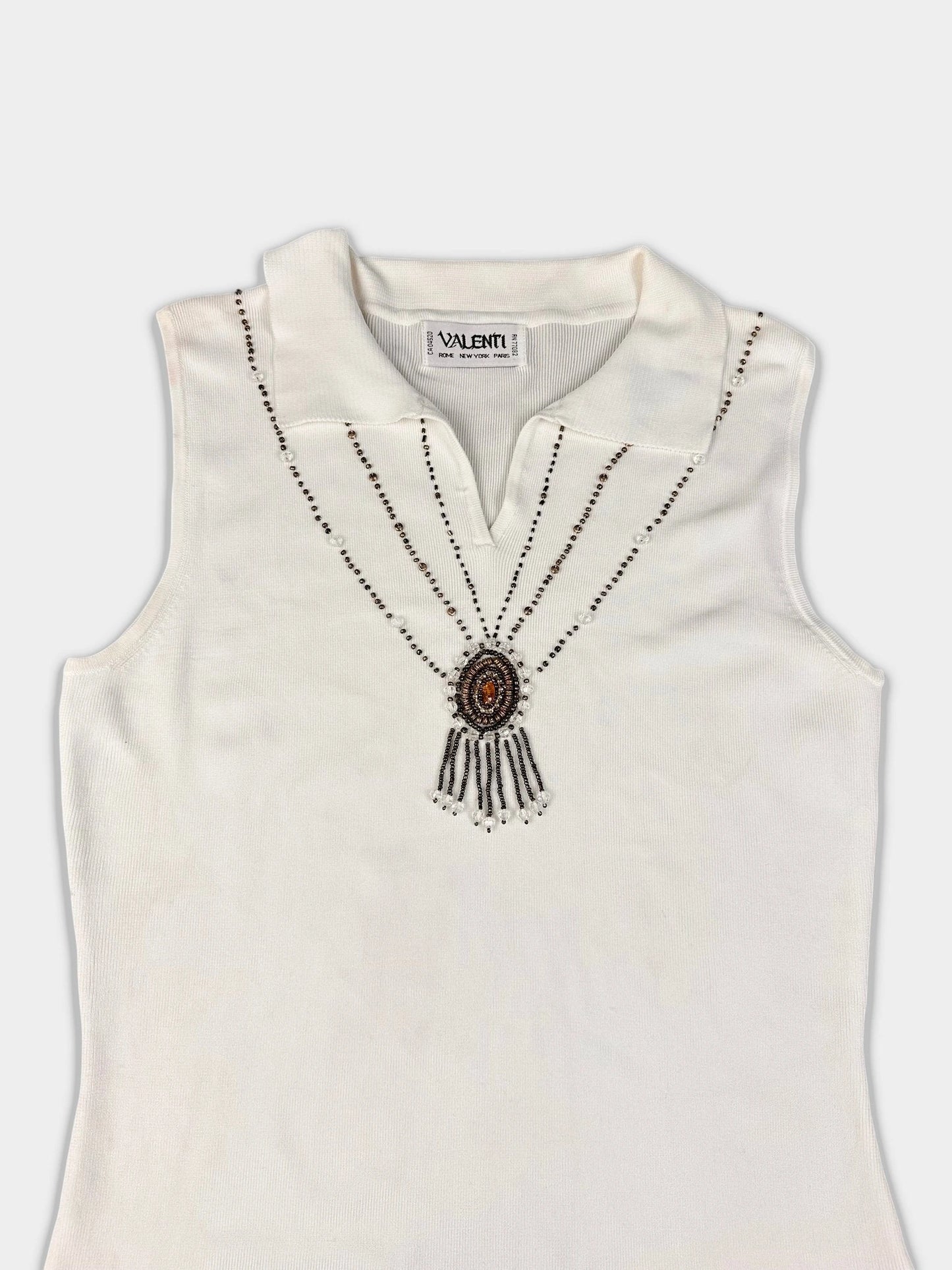Elegant sleeveless top in off-white with beaded details, detail view.