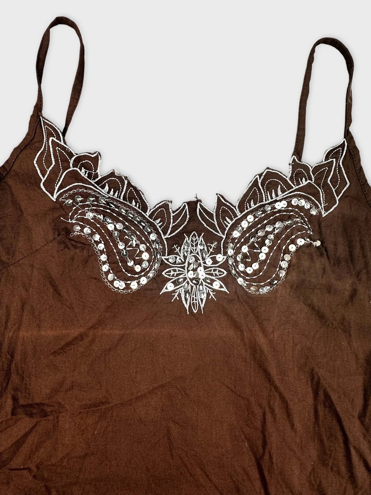 Detail view of brown cami top with embroidered floral design and embellishments
