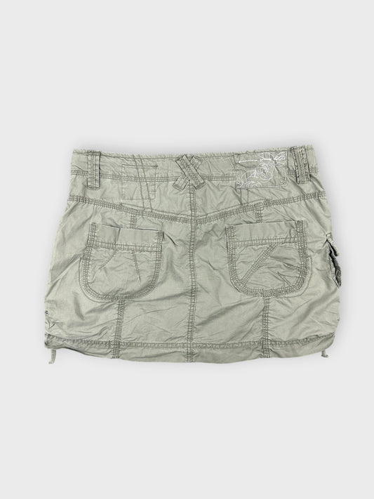 Faded green mini skirt with pocket details back view.
