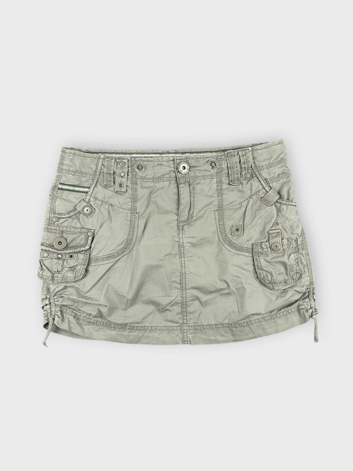 Faded green mini skirt with pocket details front view.