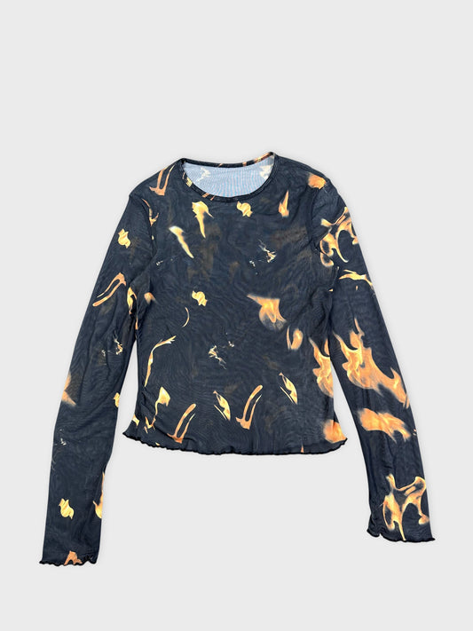 Front view of a black flame-print graphic top with long sleeves.
