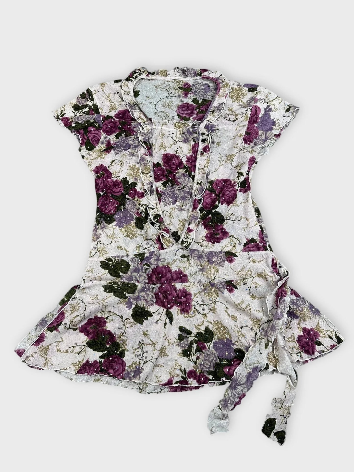 Detail view of floral mesh top featuring purple and pink floral pattern and frill trim.