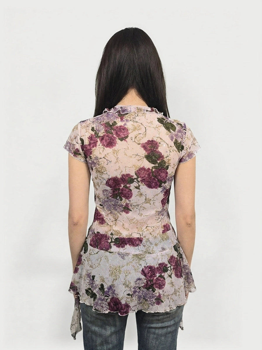 Back view of a floral frill mesh top in purple with ruffled neckline.