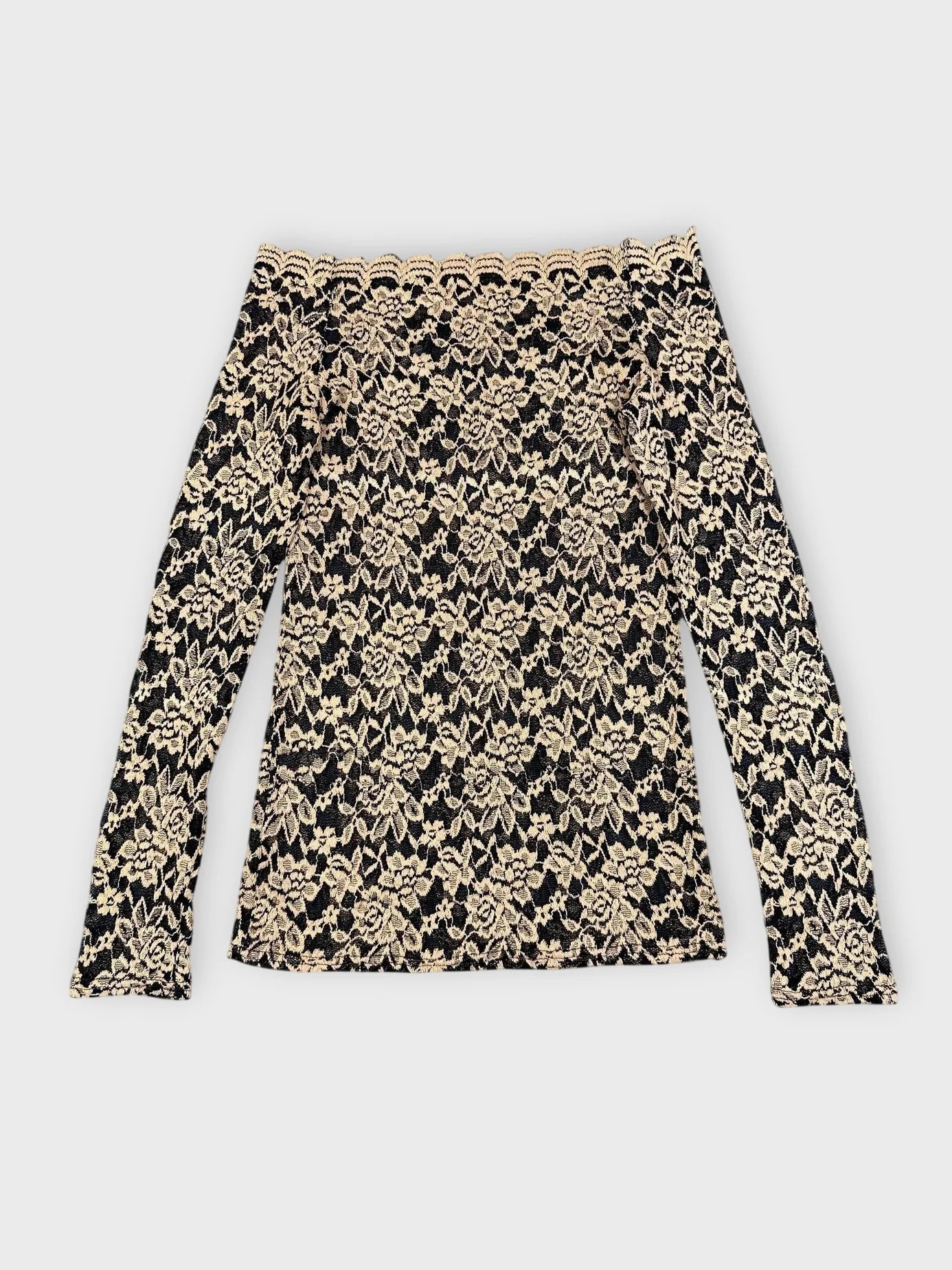 Back view of black and beige floral lace bardot top with long sleeves.