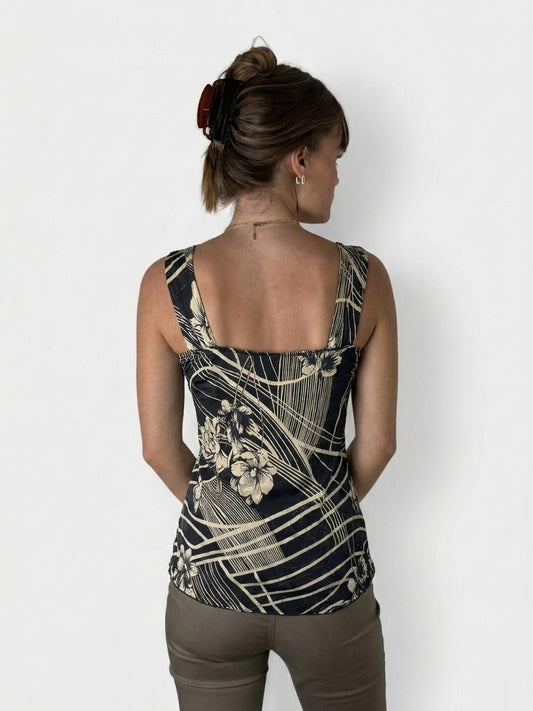Back view of a floral lace trim tank top in black with a yellow pattern.