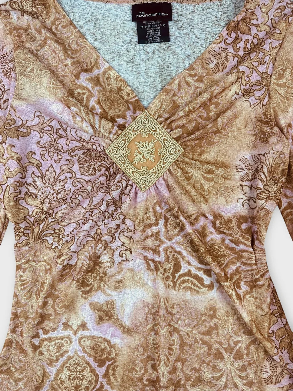 detail view of a floral long sleeve top in brown with lace detail