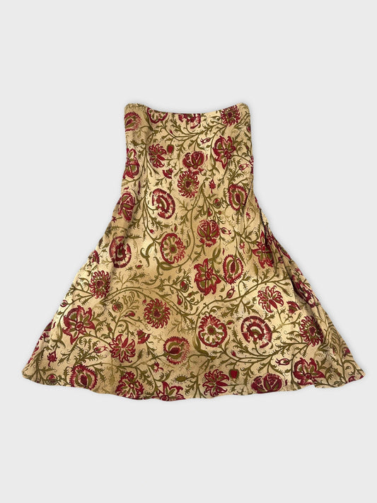 Floral maxi skirt in gold with red floral pattern back view.