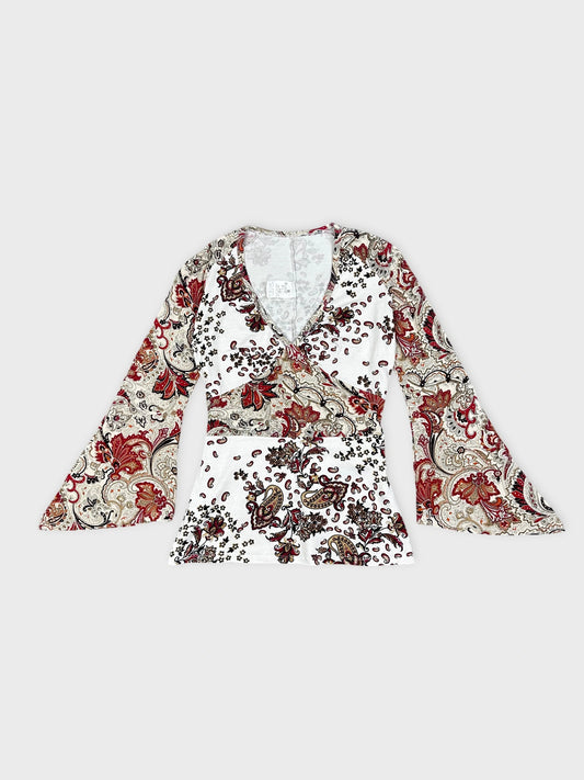 Front view of white long-sleeve top with floral paisley print and V-neck.