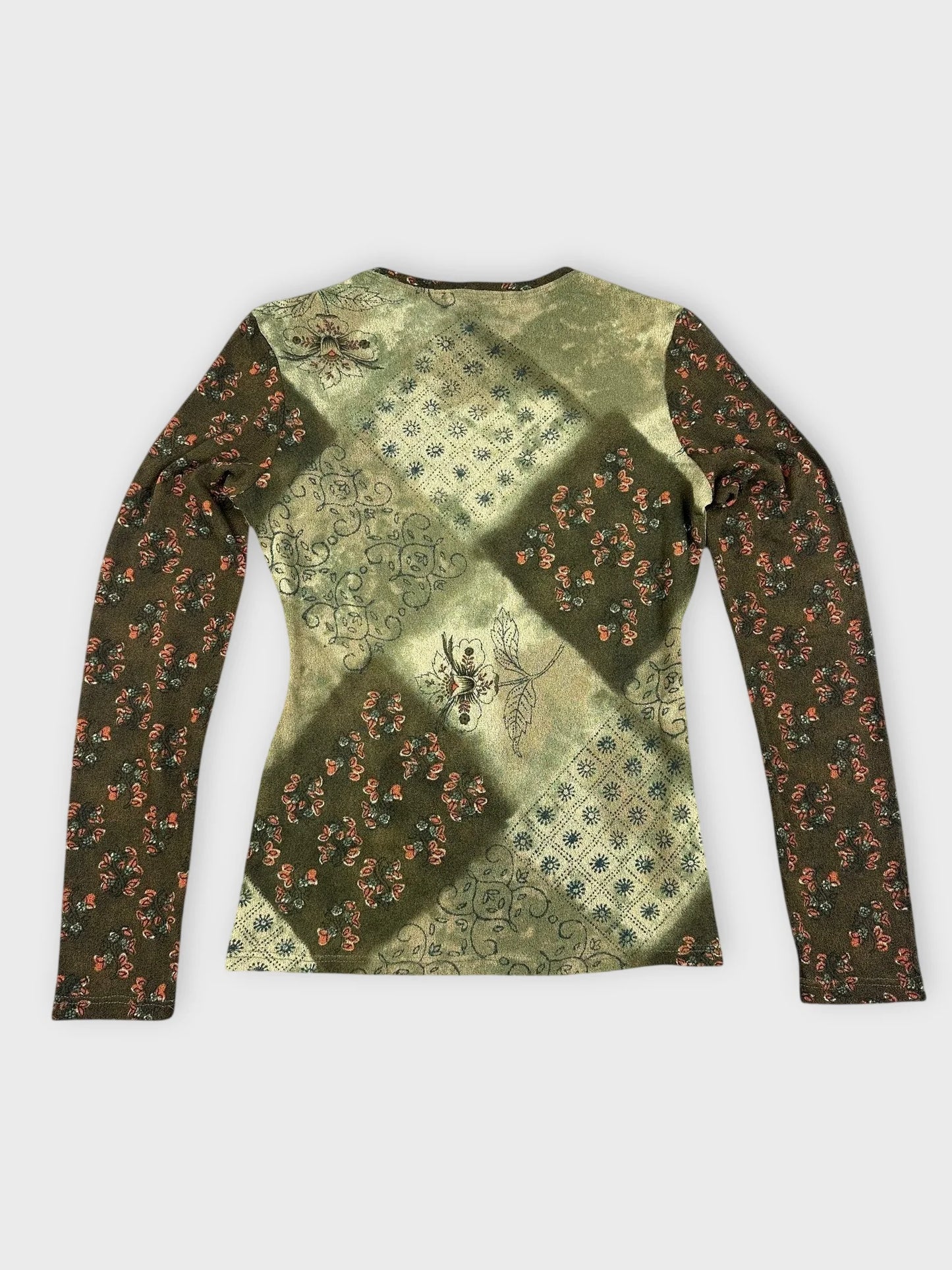 Back view of a long sleeve top in green with floral patchwork design.