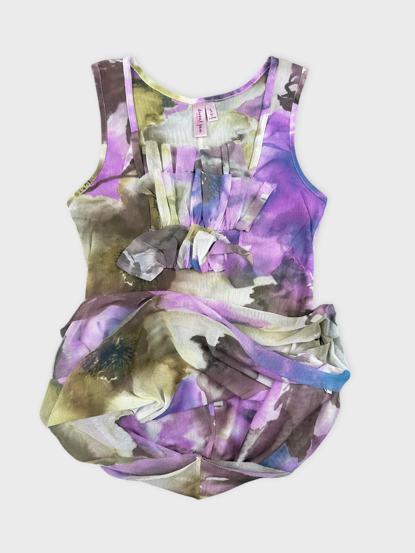 Detail view of sleeveless floral dress in lavender with ruffled front.