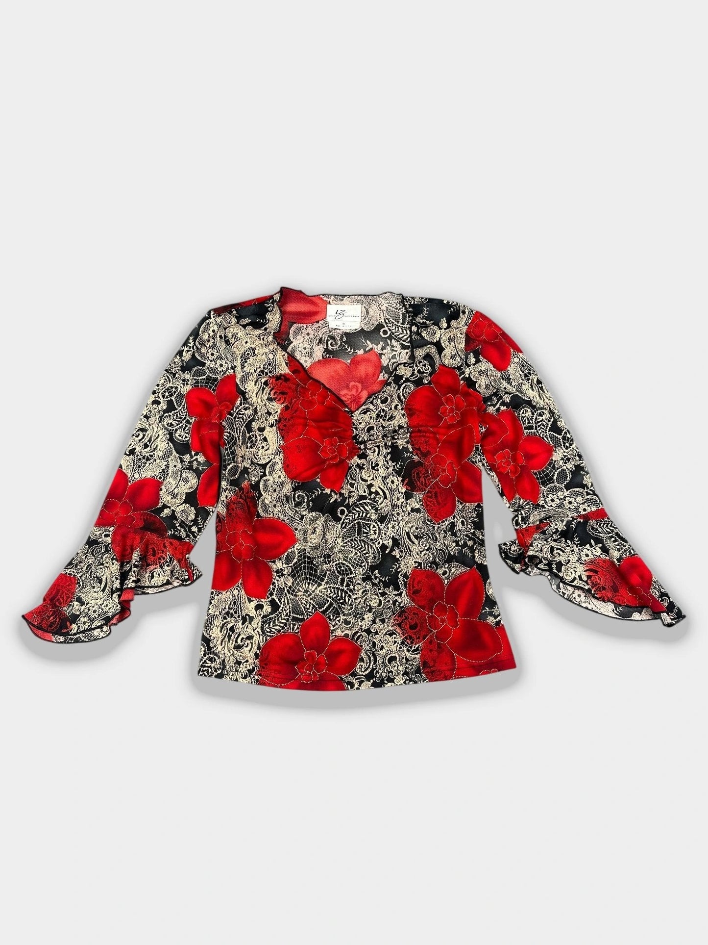 Front view of a floral long sleeve top with red flowers and ruffled sleeves.