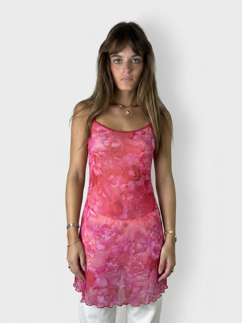 Floral sheer top in pink with adjustable straps, front view.