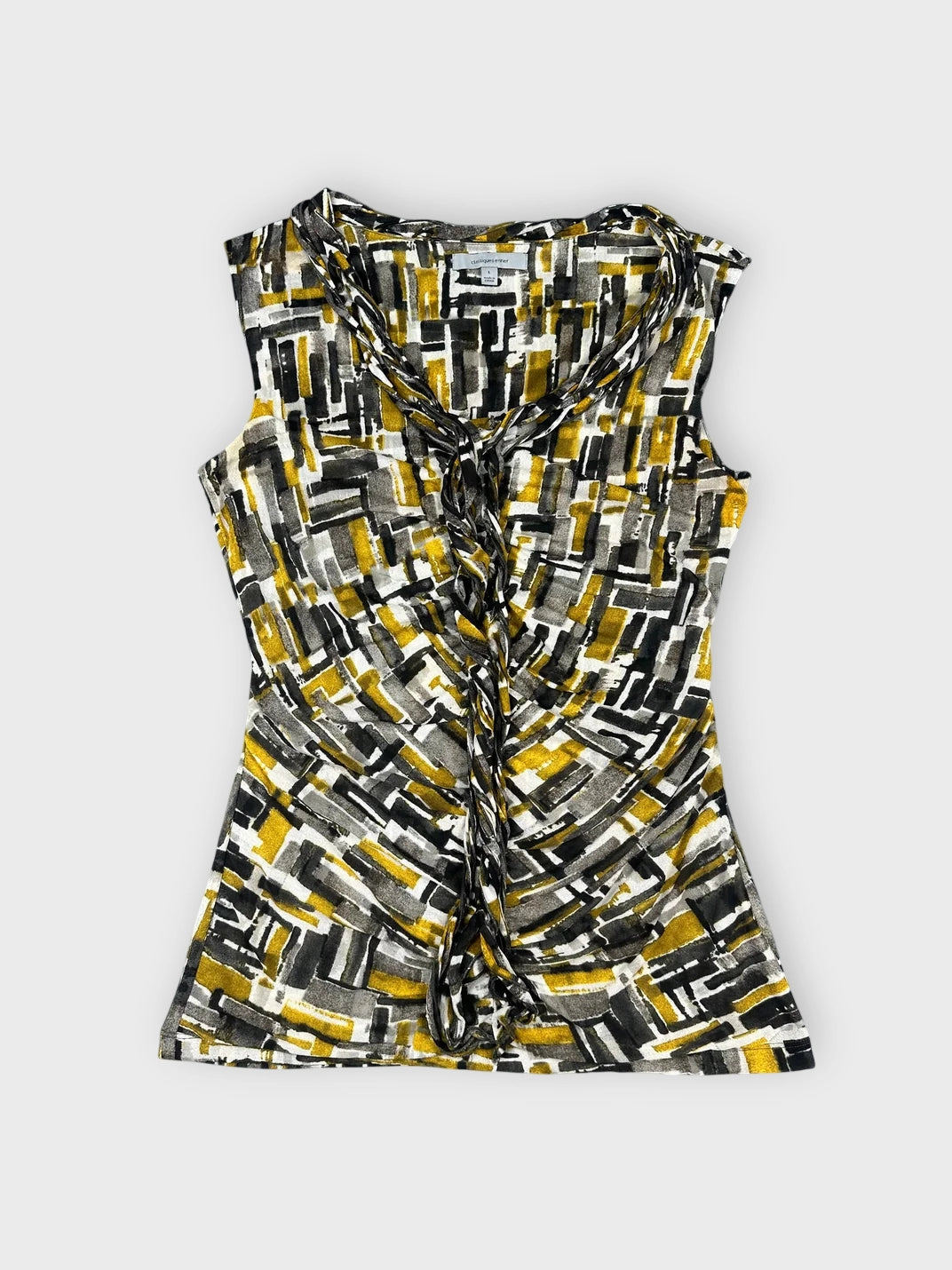 Front view of a sleeveless top in black yellow and white geometric print with ruching.