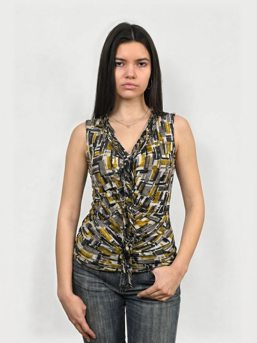 Front view of a graphic print sleeveless top in yellow, featuring ruching details.