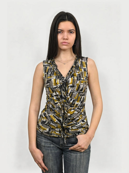 Front view of a graphic print sleeveless top in yellow, featuring ruching details.