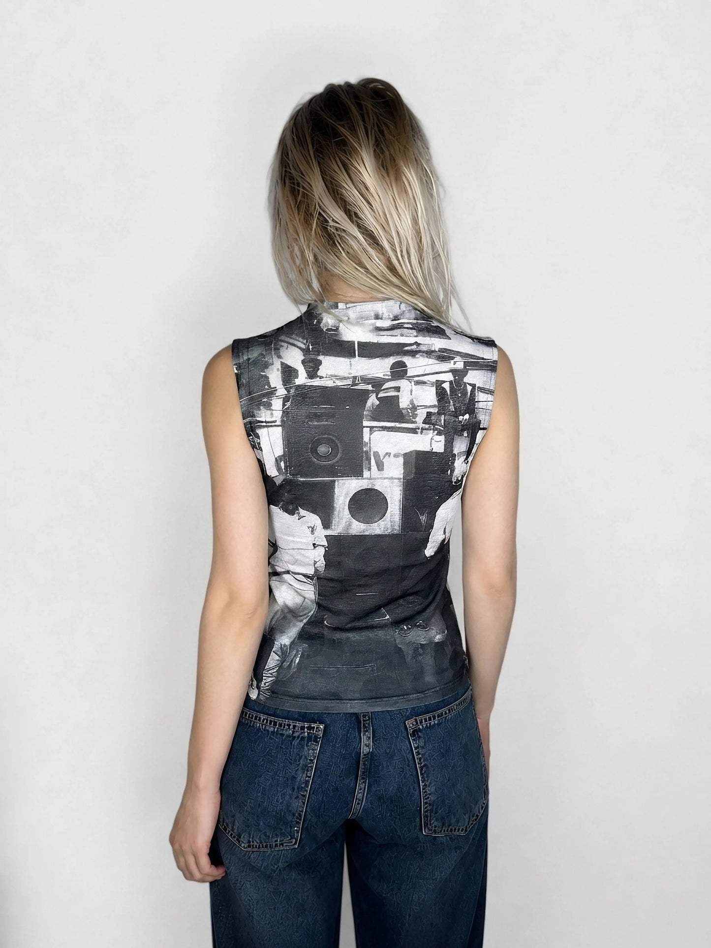 Back view of a graphic sleeveless top featuring a monochrome bold print.