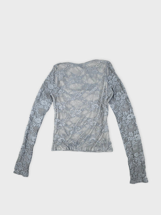 Back view of a gray long-sleeve top with floral lace pattern.