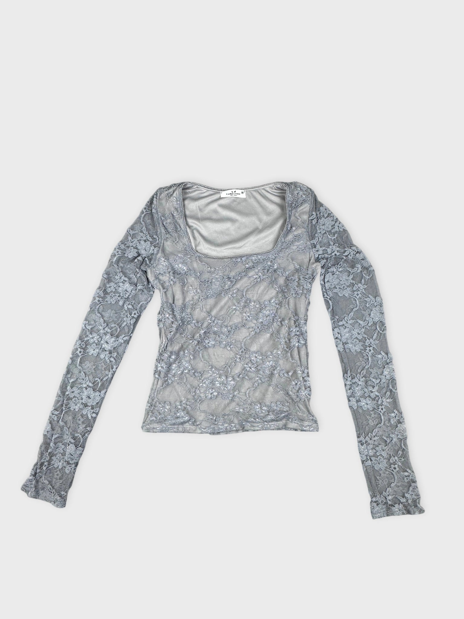 Front view of a gray long-sleeve top with lace pattern detail.