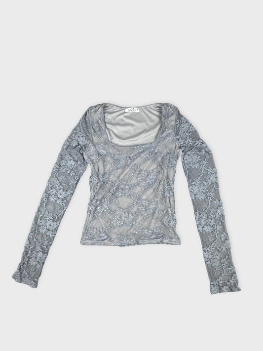 Front view of a gray long-sleeve top with lace pattern detail.