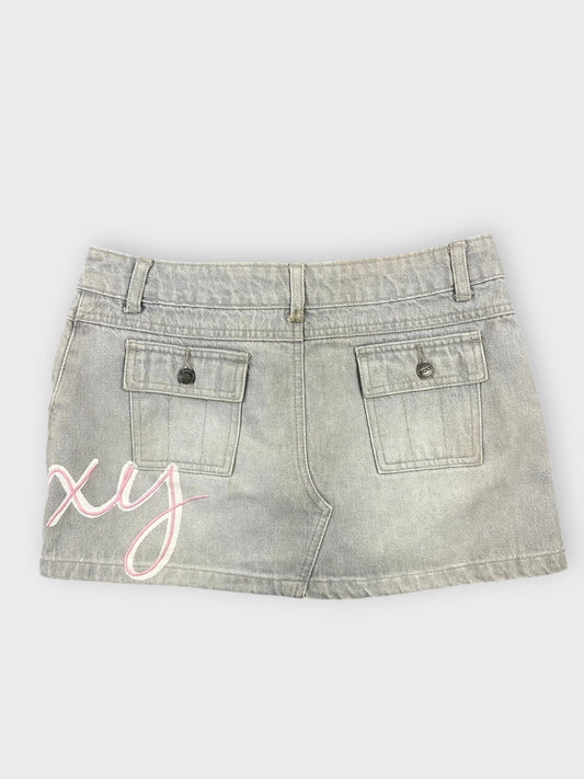 Back view of grey denim mini skirt featuring embroidered detail in pink.
