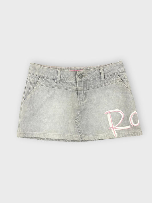Front view of grey denim mini skirt with embroidered detail.