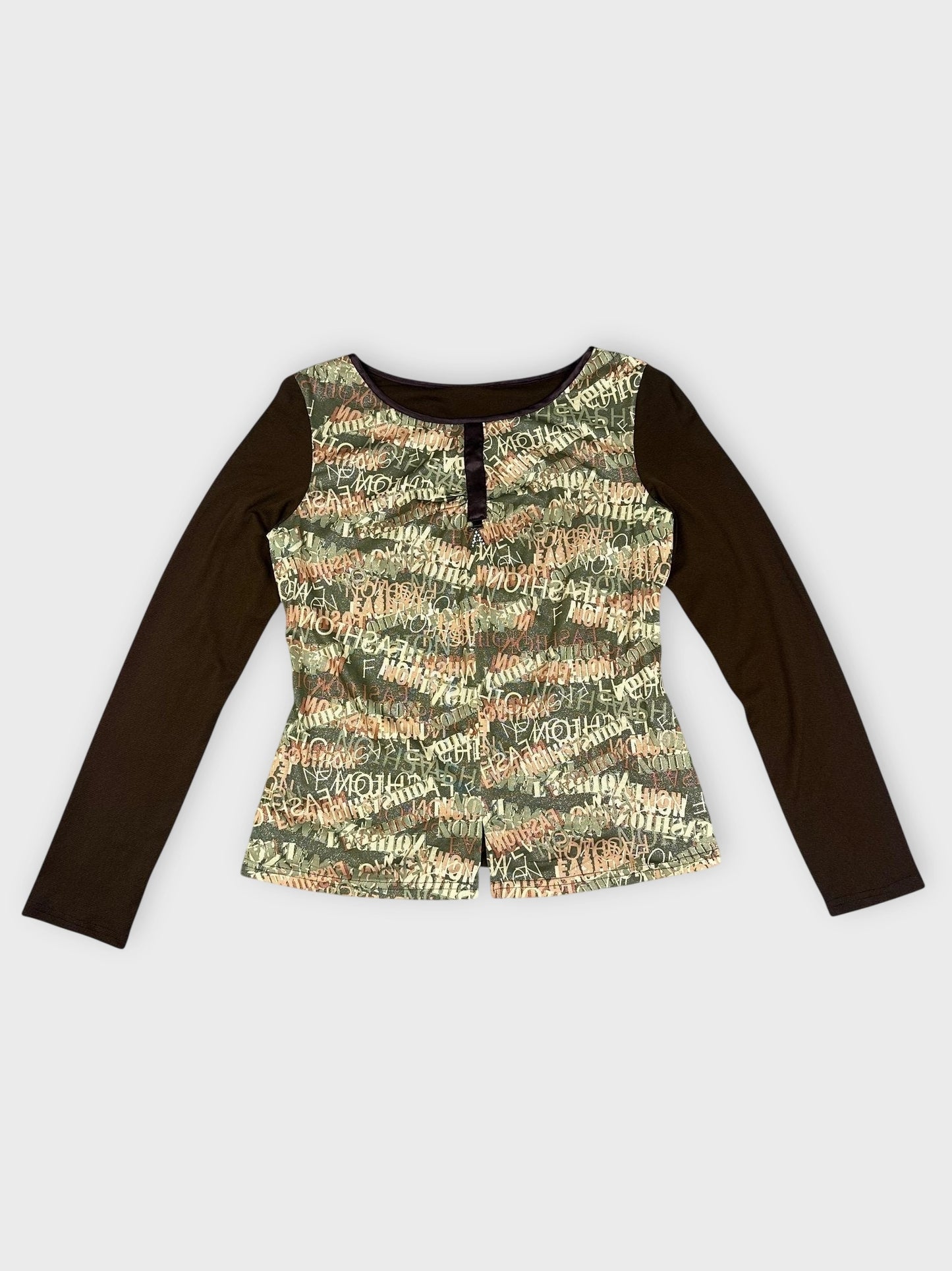 Detail view of khaki long sleeve top with text print and black trim