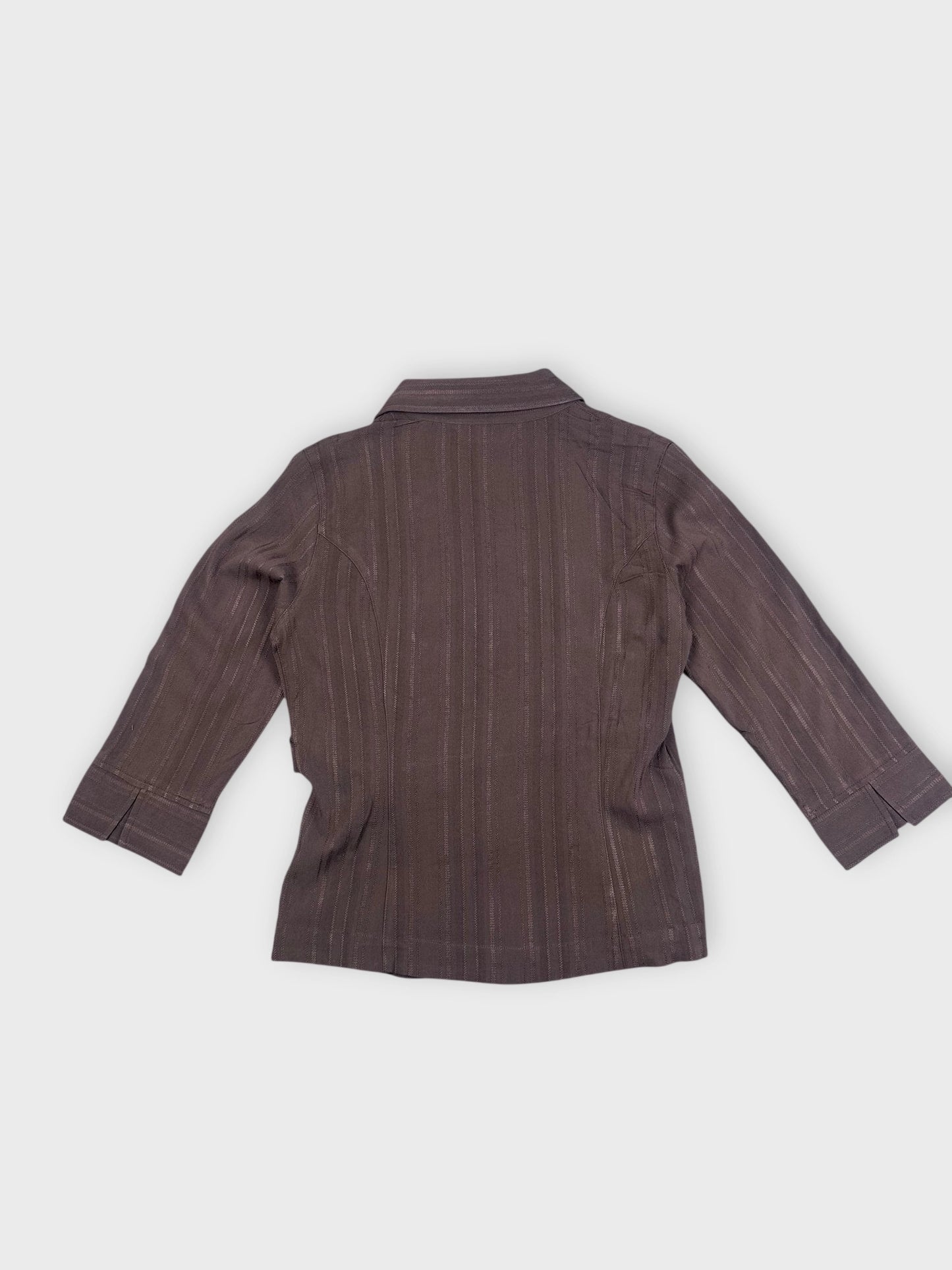 Back view of a brown wrap blouse with vertical stripe pattern.
