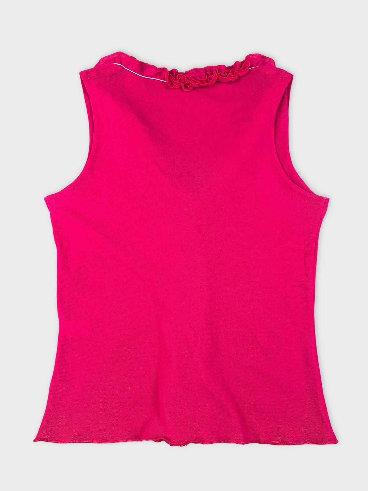 Back view of a hot pink tank top featuring a ruffled neckline detail.