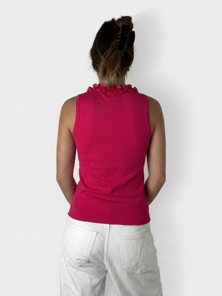 Back view of a hot pink tank top featuring a ruffled neckline.